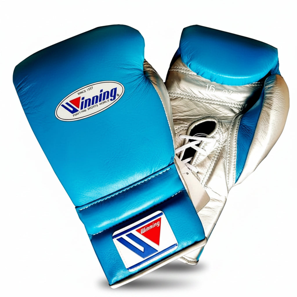 A pair of blue and silver boxing gloves with the Winning brand logo visible on the wrist strap and front pad, set against a plain white background.