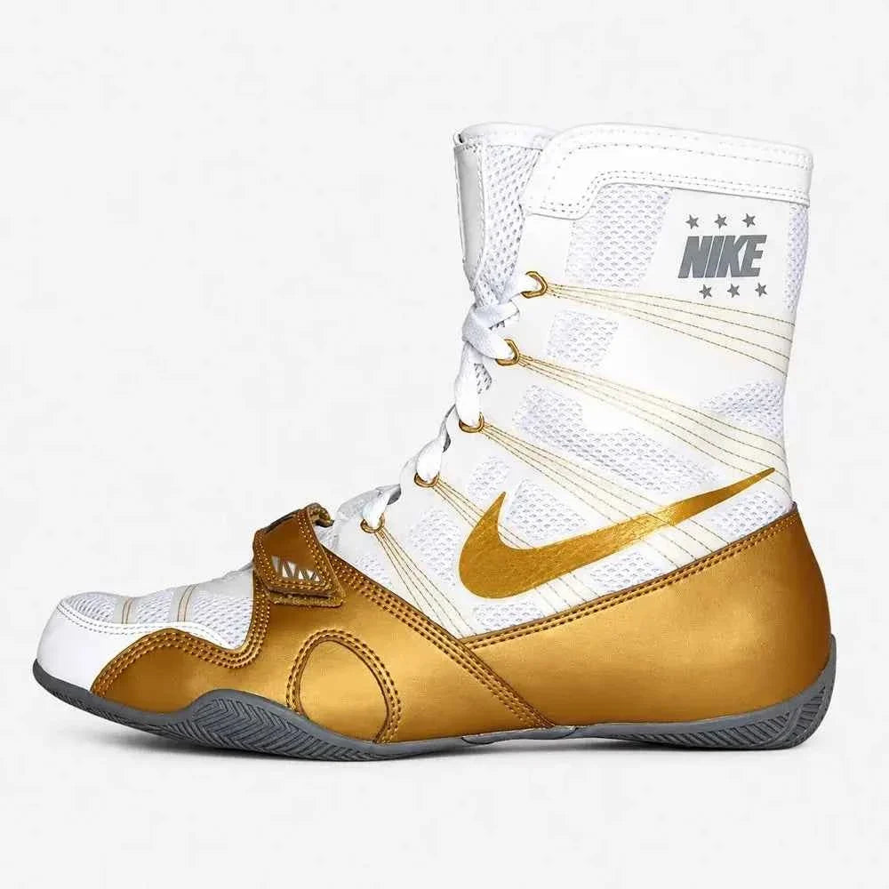 A Custom Nike HyperKO boxing shoe in a white and gold colorway, featuring a gold forefoot lockdown strap and a metallic gold Nike Swoosh, displayed on a white background.