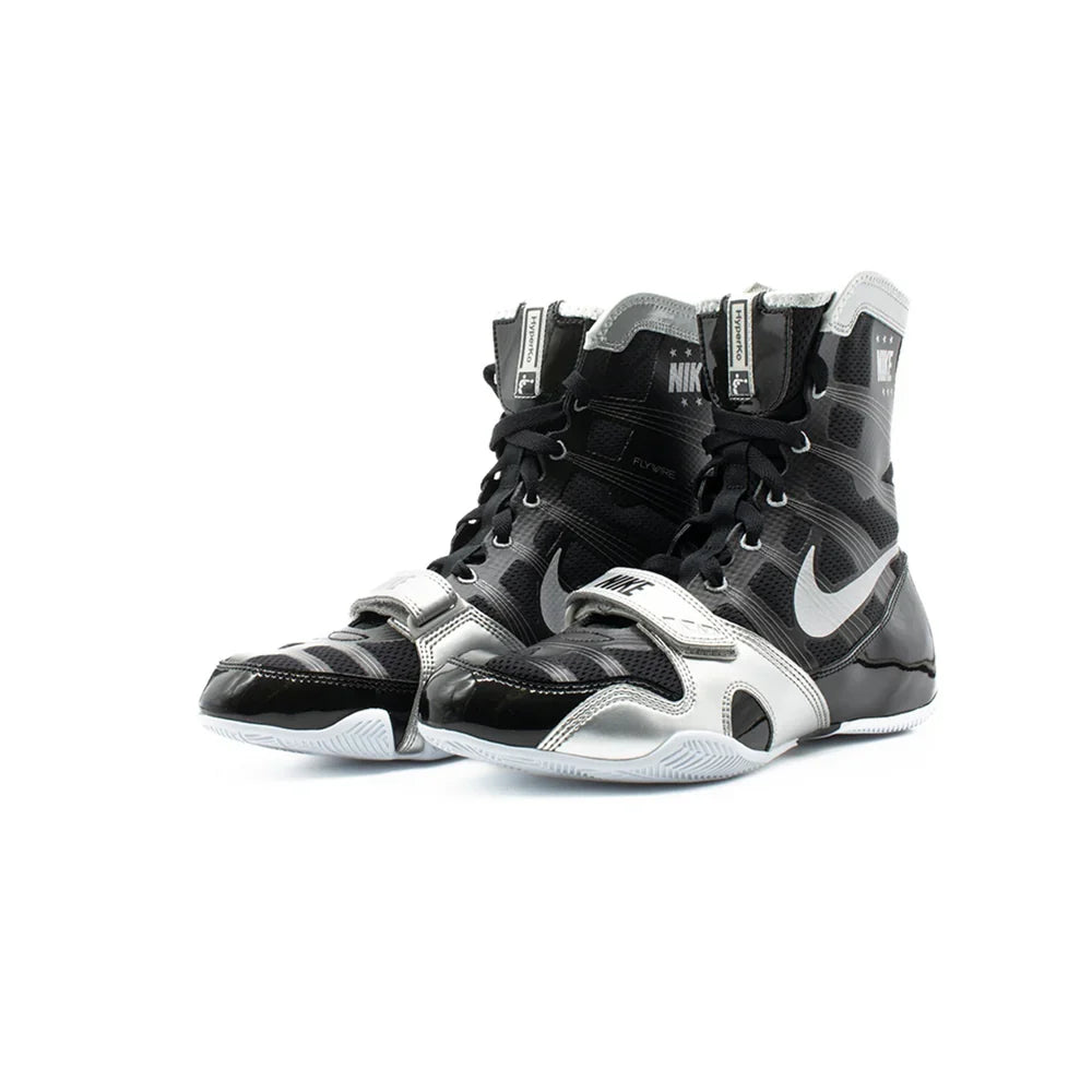 A pair of Custom Nike HyperKO boxing shoes in a black and silver colorway, featuring a forefoot lockdown strap and Nike Swoosh, displayed on a white background.
